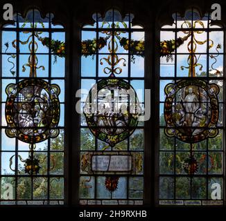 Stained glass window of wreathed oval roundels in Renaissance style by Frederick Charles Eden (1864-1944), Barsham church, Suffolk, England, UK c 1907 Stock Photo