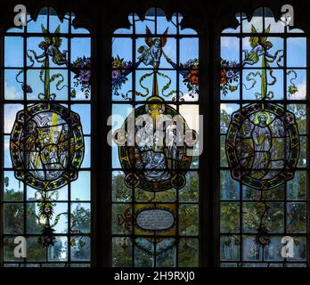 Stained glass window of wreathed oval roundels in Renaissance style by Frederick Charles Eden (1864-1944), Barsham church, Suffolk, England, UK c 1907 Stock Photo