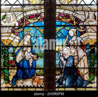 Renaissance Flemish style stained glass window of Blessed Virgin Mary and baby Jesus with two women, by J. Fisher c 1903, Barsham church, Suffolk, Eng Stock Photo