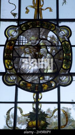 Stained glass window of wreathed oval roundel in Renaissance style by Frederick Charles Eden (1864-1944), Barsham church, Suffolk, England, UK c 1907 Stock Photo