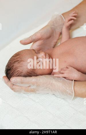 Professional physiotherapist performing an assessment of cervical ...