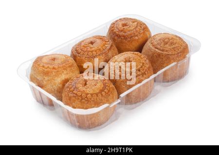 Studio shot of a tray of small pork pies cut out against a white background - John Gollop Stock Photo