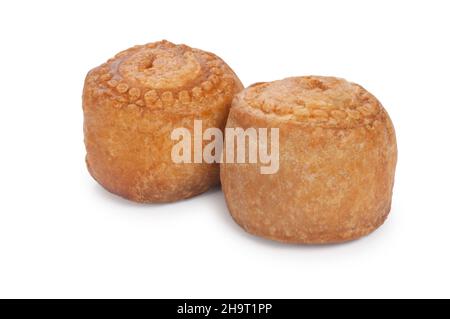 studio shot of small pork pies cut out against a white background - John Gollop Stock Photo