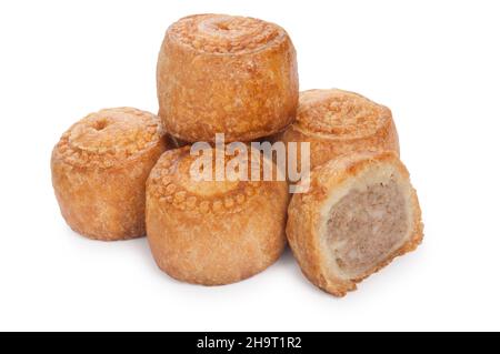 studio shot of small pork pies cut out against a white background - John Gollop Stock Photo