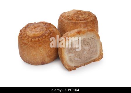 studio shot of small pork pies cut out against a white background - John Gollop Stock Photo