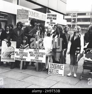 1970s, historical, group of people, mainly women, with banners and placards, making a protest outside a shopping centre about the failure of Southwark Council to offer free birth control and contraception. A poster reads, 'Southwark Spends More on Rat Control Than Birth Control'. The ability of unmarried young  women to access contraception and prevent unwanted pregancies remained limited up until the end of the 1970s. Stock Photo