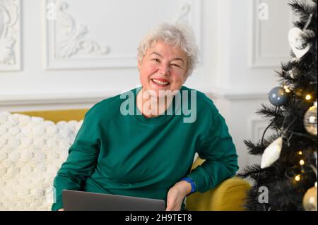 grandma is talking on a video conference with her family. Modern means of communication Stock Photo