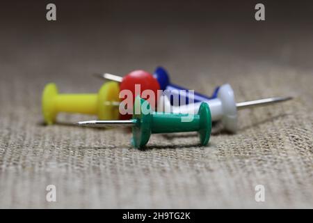 View of a bunch of colored stationery buttons on a blurred background. Stock Photo