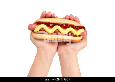 Hot dog in woman hand isolated on white background. Copy space. Stock Photo