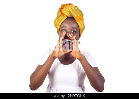 beautiful young woman wearing traditional holding, giving a big scream with hands next to the mouth Stock Photo