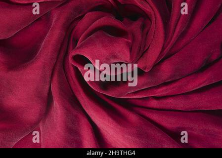 Soft smooth burgundy silk fabric background. Fabric texture. Stock Photo