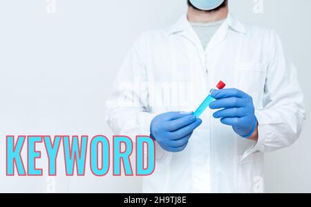 Hand writing sign Keyword. Word Written on word which acts as the key to a code Concept of great significance Doctor Analyzing New Medicine, Scientist Stock Photo