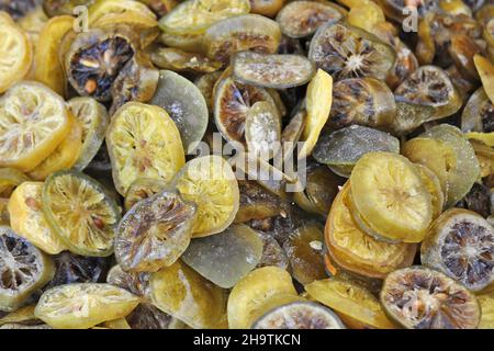 lime fruit (Citrus aurantifolia), dried lime slices at a market, Italy Stock Photo