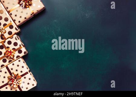 Gift boxes with golden bows on blue background. Stock Photo