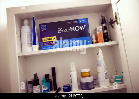 View of Abbott at-home rapid covid-19 tests in boxes of two on a shelf in a bathroom cabinet alongside personal hygiene products, New York City, NY 10 Stock Photo