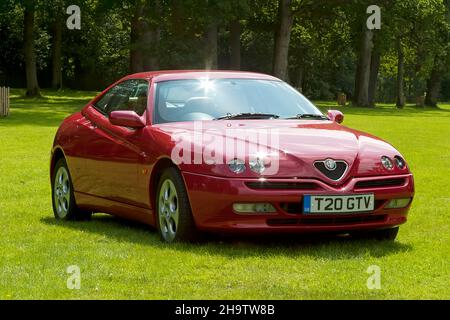 Longleat House, Wiltshire, UK - July 25 2004: An Italian made 1999 Alfa Romeo GTV (Gran Turismo Veloce) (Phase 2) 2+2 Coupe sports car. Stock Photo