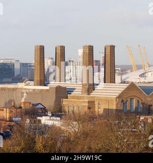 London, Greater London, England, December 04 2021: Building with four distinctive chimneys in Greenwich with the O2 building behind. Stock Photo