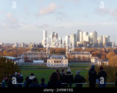 London, Greater London, England, December 04 2021: Tourists enjoying the view from the hill in Greenwich Park towards Queens House and the University, Stock Photo