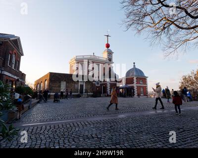 London, Greater London, England, December 04 2021: Tourists taking photos on the Meridian Line which marks the Prime Meridian point, Royal Observatory Stock Photo