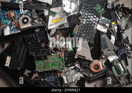 '24.10.2021, Singapore, , Singapore - A pile with electronic waste (e-waste) from components of two old discarded laptop computers with circuit boards Stock Photo