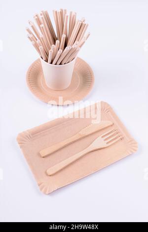 Eco friendly disposable tableware. Paper plates, cups, straws, wooden cutlery on white background. Zero waste, plastic free items. Sustainable lifesty Stock Photo
