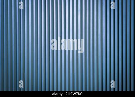 bright vertical folding blinds bright blue Stock Photo