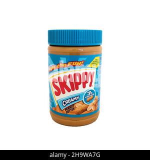 A 16.3 ounce or 462 gram jar of Skippy creamy peanut butter on a white background with the "Fuel the Fun" trademark tag line; Hormel Foods brand. Stock Photo