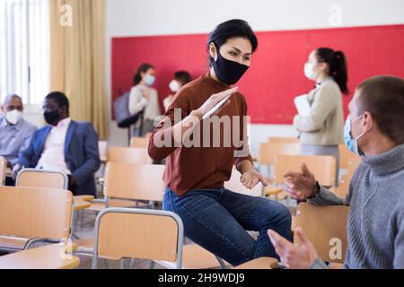 Students wearing protective mask in classroom Stock Photo