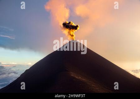 Fuego volcano erupting at sunset, Antigua, Guatemala Stock Photo