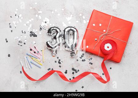 Birthday composition with silver balloons in shape of figure 30 on light background Stock Photo