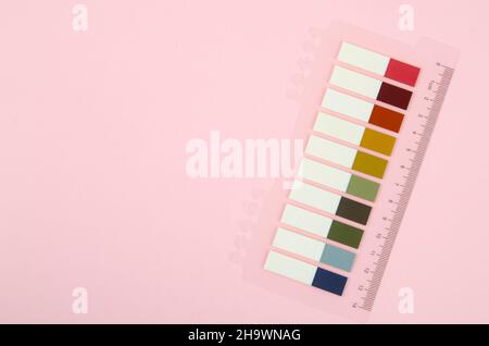 Set of multicolored sticker paper index sticky note with ruler on pink background. Stock Photo