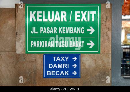 A sign at the exit of Yogyakarta train station in Central Java, Indonesia showing where to find a becak, taxi and damri bus. Stock Photo