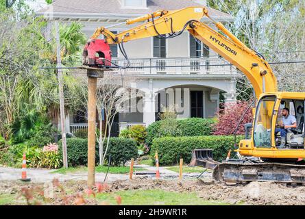 NEW ORLEANS, LA, USA - MARCH 22, 2021: Man operating pile driver for new construction in Uptown neighborhood Stock Photo