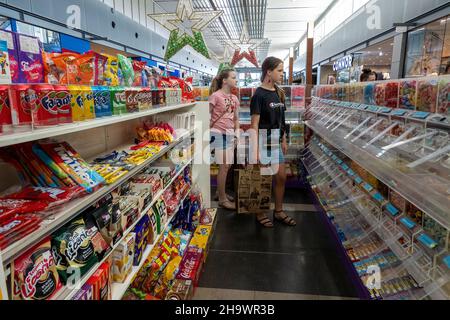 Mackay, Queensland, Australia - December 2021: Two young girls in a confectionery store choosing their sweets