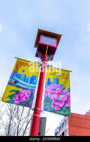 CALGARY, CANADA - NOVEMBER 13, 2021: Chinese lantern-style street lamp with colorful banners in downtown Chinatown in Calgary. Stock Photo