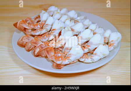 Plate of Mouthwatering Steamed Flower Crab Legs on Wooden Table Stock Photo