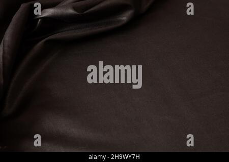 Black satin background luxury textile texture, silk cloth wave material, Christmas abstract dark backdrop, elegant shiny wallpaper template Stock Photo