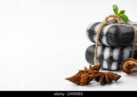 Pieces of natural black handmade soap on white background Stock Photo