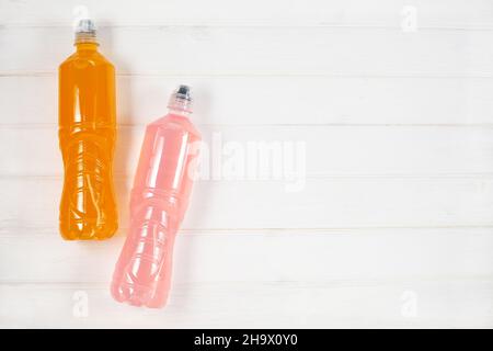 Energy drinks with different flavors on a white wooden background. Sport beverage. Stock Photo