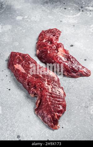 Machete steak raw cut or hanging tender cut. Gray background. Top view Stock Photo