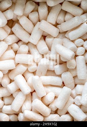 Full frame with packing peanuts, the vertical image of packing peanuts, or packing protector. Close-up image. Stock Photo