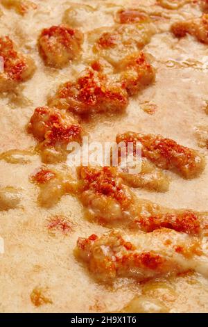 Closeup of deep-fried chicken pieces in melted cheese on pizza Stock Photo