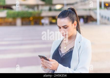 elegant woman typing on her mobile phone Stock Photo