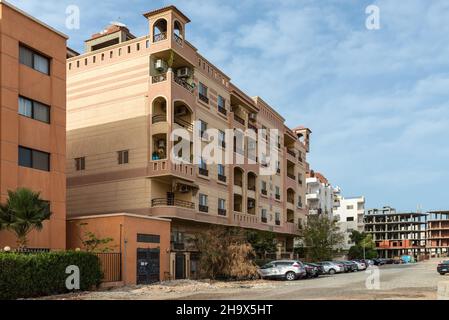 Hurghada, Egypt - May 31, 2021: Street view of Hurghada with parked cars near residential buildings, popular beach resort town along Red Sea coast of Stock Photo