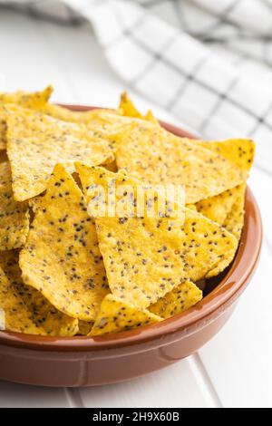 Salted tortilla chips triangle with chia seeds in bowl. Stock Photo