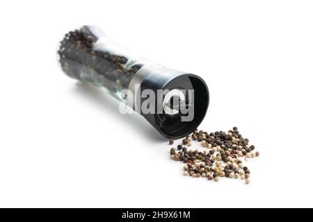 Pepper mill and whole pepper isolated on white background. Stock Photo