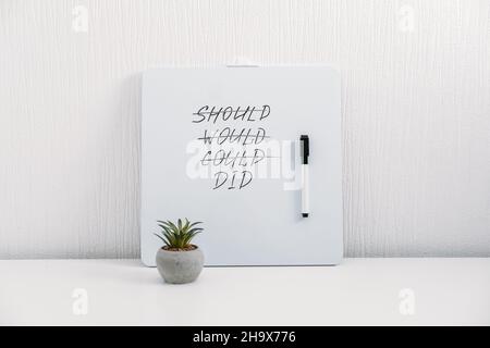 Should Would Could Did handwriting text quote on white board on table at home or office. Inspirational, Motivational, Positive quote for Girl Boss Stock Photo