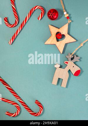 Christmas candy canes. Wooden Christmas tree toys. Christmas deer. Star with a bell. Stock Photo