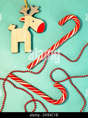 Christmas candy canes. Christmas deer. Red Christmas beads. Retro style. Stock Photo