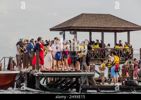 TUNKU ABDUL RAHMAN PARK, MALAYSIA - FEBRUARY 24, 2018: People at a pier at Sapi Island in Tunku Abdul Rahman National Park, Sabah, Malaysia Stock Photo